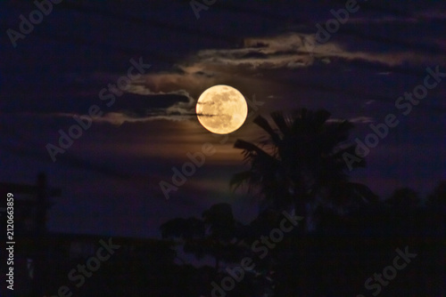 Full moon in the night sky with clouds
