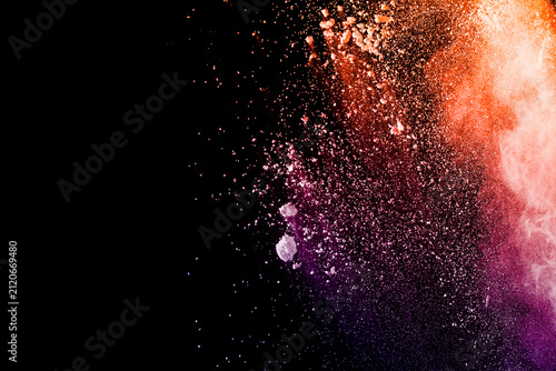 Orange purple powder explosion on black background. Orange purple color dust splash.