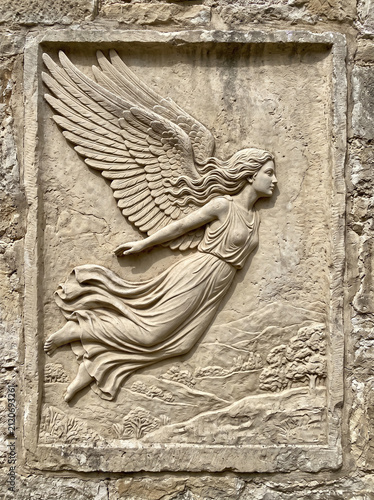 stone relief featuring a classical-style winged angel