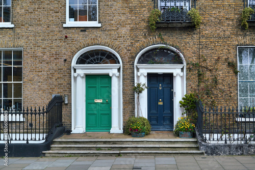 Photography Georgian brick townhouses with fanlight windows above the doors, used as profess
