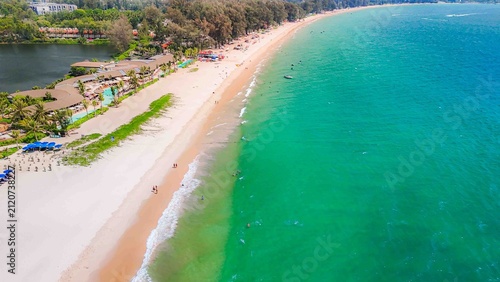 Aerial drone panoramic footage capturing the midday sun at Bang Tao Beach and the stunning Phuket sea. A concept for tropical tourism photography in Thailand.