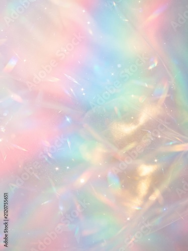 Abstract holographic foil background with iridescent pastel rainbow light reflections and shimmering glossy texture