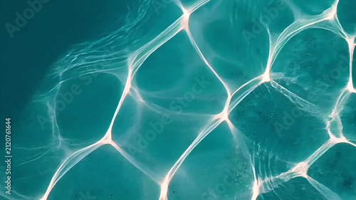 Summer hot vibe lifestyle. A topdown view of a body of water reveals a complex network of interconnected, translucent, hexagonal structures. The waters surface is a deep turquoise.