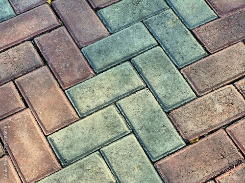 Colorful brick paving stones arranged in herringbone pattern