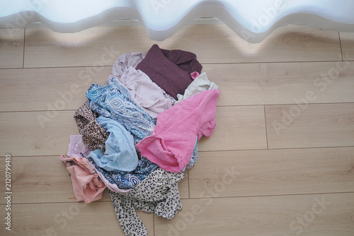 Canvastavla Clothes lying on wooden floor in a room