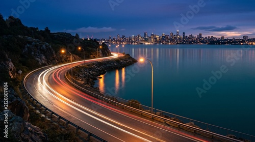 Urban Waterfront Skyline at Night with Highway Light Trails