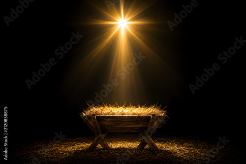 A nativity scene with empty manger and a bright star at night with Christmas concept