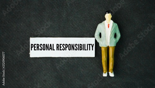 Miniature people and paper with the word personal responsibility. the act of owning your choices, actions, and reactions