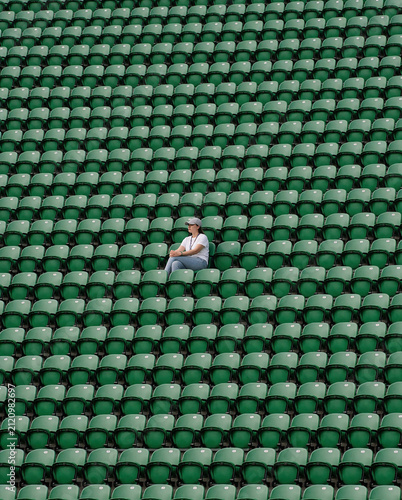 vast stadium green folding chair with a woman sitting 1