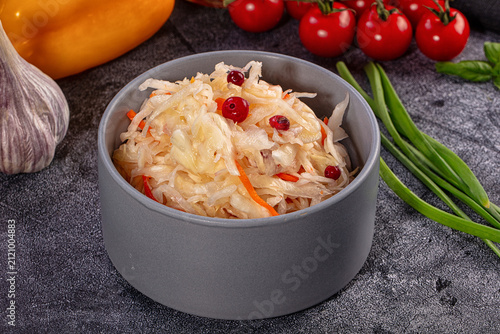 Cuadro en lienzo Sauerkraut with cranberry and carrot in grey bowl with fresh vegetables