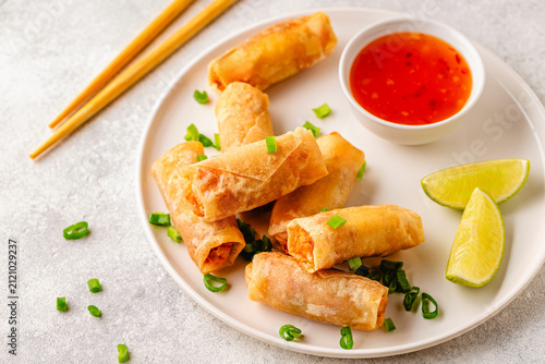 Fried spring rolls served with lime and sauce