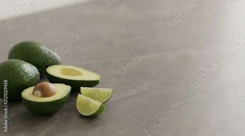 Whole and sliced fresh green avocado and lime on textured surface