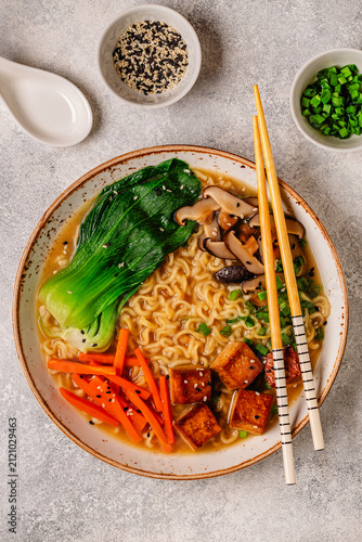 Fotografie Noodles ramen miso soup served with tofu, bok choy, carrots, and mushrooms