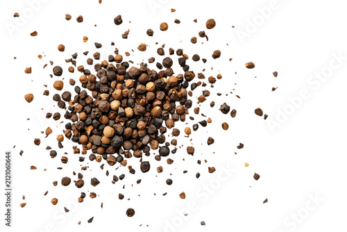 Black peppercorn pile with dispersed fragments isolated