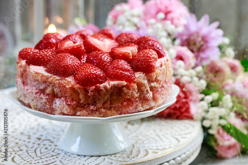Strawberry cake on cake stand.