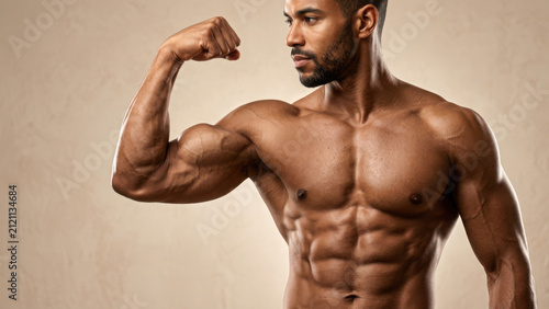 Fit man with muscular physique flexing his arm and biceps against a neutral generated using ai