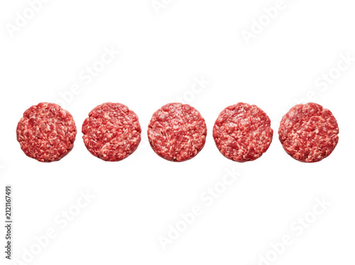 Raw beef burger patties in a row, fresh minced meat rounds for grilling and BBQ, butchery product isolated on black for menu design and advertising