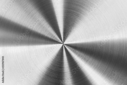 Circular brushed metal texture, silver metallic background macro photography.