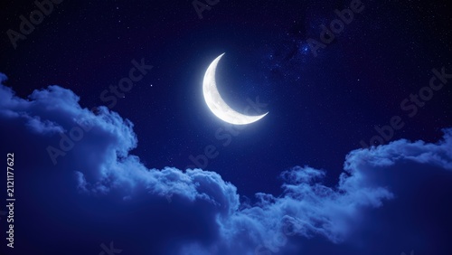 Beautiful Crescent Moon and Starry Night Sky Over Blue Clouds