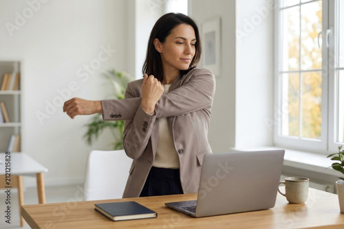 Businesswoman stretching shoulder during office break supporting healthy work habits