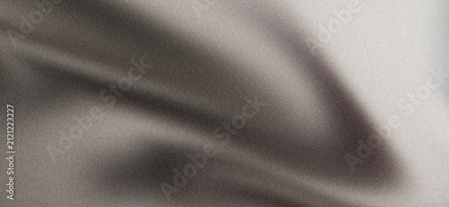 Soft gray brown and cream flowing fabric waves on light grainy background with elegant folds and neutral abstract texture