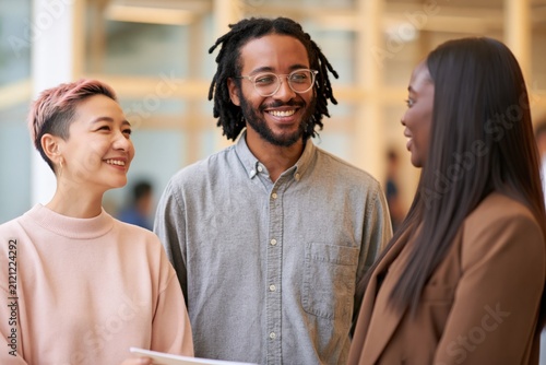 Smiling professional trio in modern office setting for corporate networking background and team meeting banner use