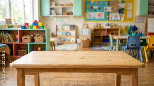 Empty wooden table in a colorful preschool classroom with toys and furniture in background
