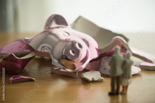 Senior couple are looking at broken piggy bank. No savings for retirement, poor, bankruptcy, financial problem, no financial planning for future, social issue, financial literacy and so on concept.