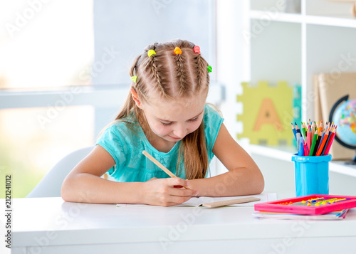 Картината върху платно Girl Doing Homework At Home In A Children's Room