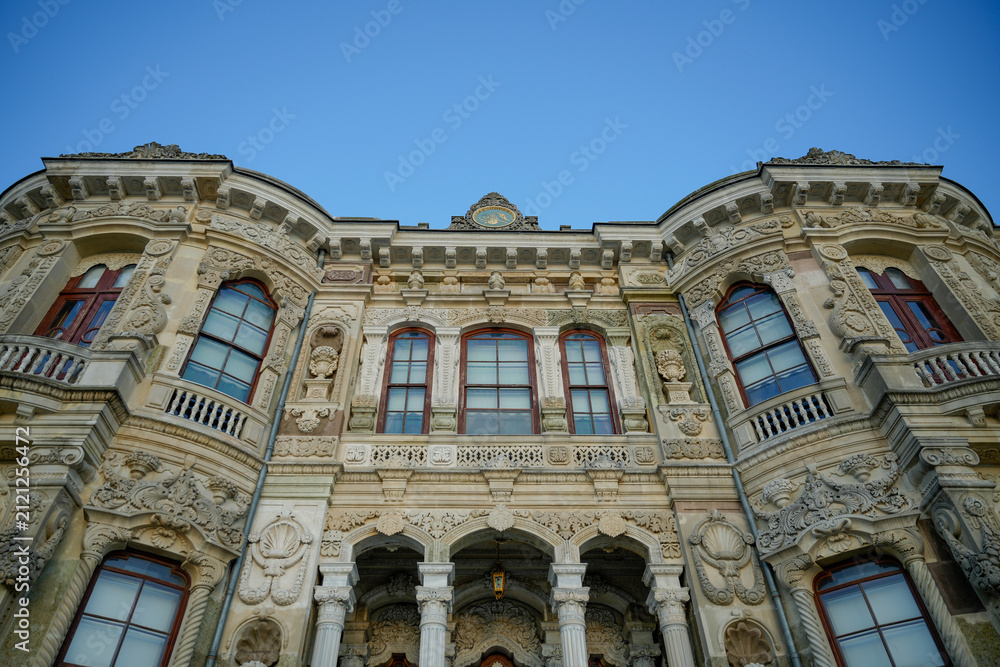 Obraz premium Küçüksu Pavilion facade, Istanbul. Exquisite Ottoman architecture, intricate Baroque stonework, windows, clear blue sky. Travel, history background.