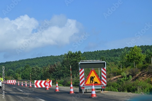 Road repairs and temporary traffic management on the A-6 motorway in Spain. Traffic cones, warning signs and a mobile information board guide traffic, June 29, 2026
