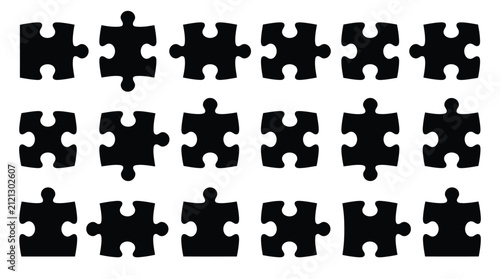 Dark black jigsaw puzzle pieces arranged in neat rows isolated against a plain white background surface