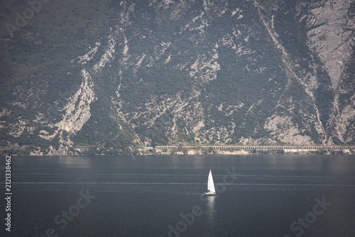 Sailboat on Lake Garda with Snow-Capped Mountains, Italy