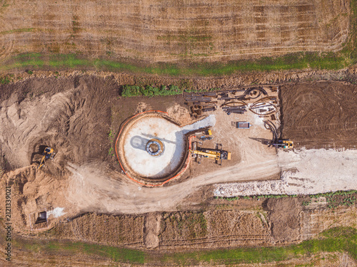 Wind turbine construction site, buildings with cranes view from a drone