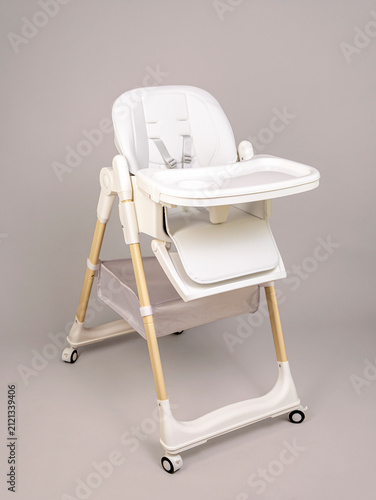 White adjustable high chair with tray and wheels