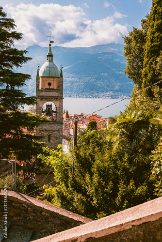 Historic bell tower rising above Lake Como in the small village of Bellano