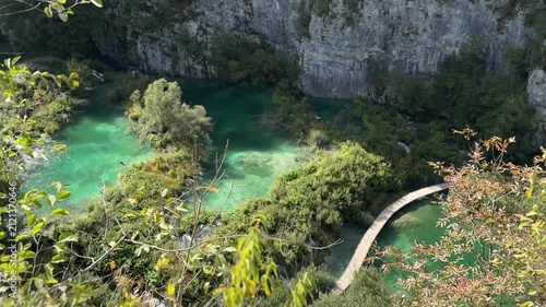 Plitvica Selo, Croatia - October 06, 2025: Plitvice Lakes National Park, Croatia. Waterfall cascading into tranquil lake surrounded by lush greenery and rocky formations in serene natural setting