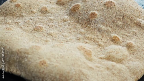 Wheat flatbread puffing up on hot skillet