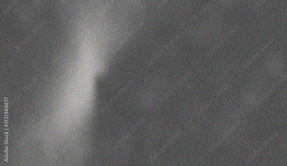 Фотография Dark dramatic grey grainy texture featuring a vertical bright light beam creatin