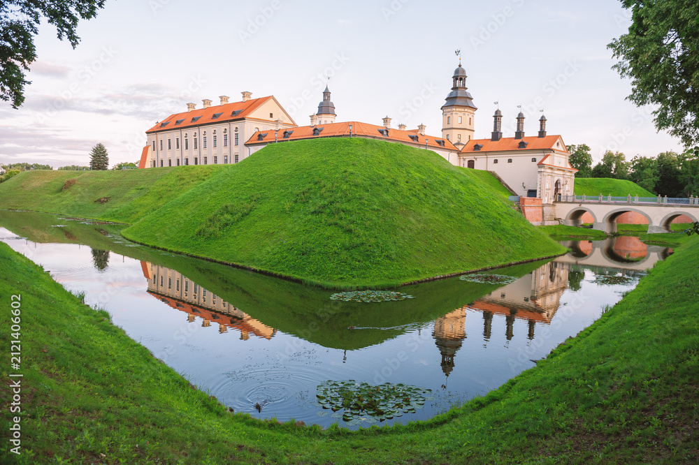 Naklejka premium Historic castle reflects across tranquil water