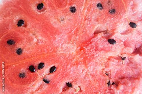 Obraz na plátně Close-up of ripe red watermelon pulp with black seeds background