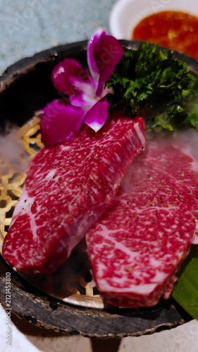 Juicy fresh premium raw meat steak preparing for grill in Japanese style BBQ barbecue at restaurant. fresh Kobe Wagyu beef raw sliced with marbled texture.