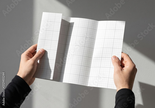 Hands Holding Four Accorderon Pages Flyer Brochure Mockup