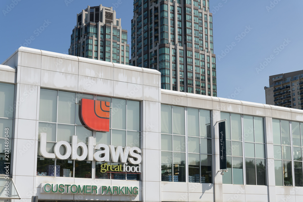 Fototapeta premium exterior building facade and logo sign of Loblaws, a grocery store chain, located here at 396 St Clair Av W, Toronto