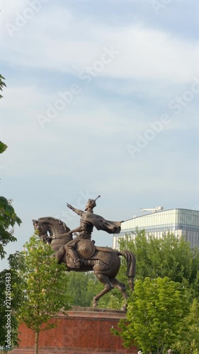 Amir Timur equestrian statue in Tashkent framed by trees and sky