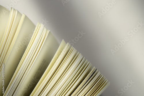 Bild auf Leinwand Abstract Close-Up of Open Book Pages,Macro,Close-up abstract perspective of white pages fanned out in a book, creating dynamic geometric lines, patterns, and a clean minimalist texture