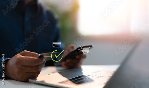 A man makes a purchase on Internet on mobile smart phone with credit card, online payment, shopping online, e-commerce, internet banking, spending money. E-commerce and online shopping concept.
