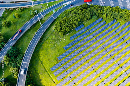 Top down view of solar panels and curved highway