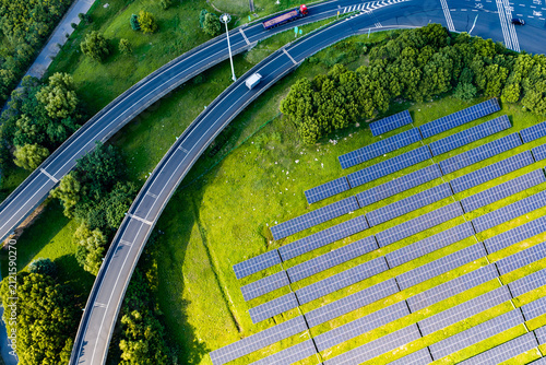 Solar panel rows and highway traffic from above