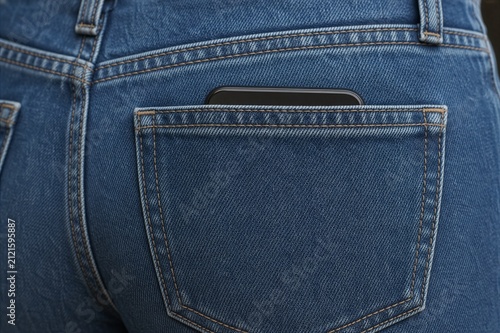 blue denim jeans feature a dark smartphone partially visible in the rear pocket